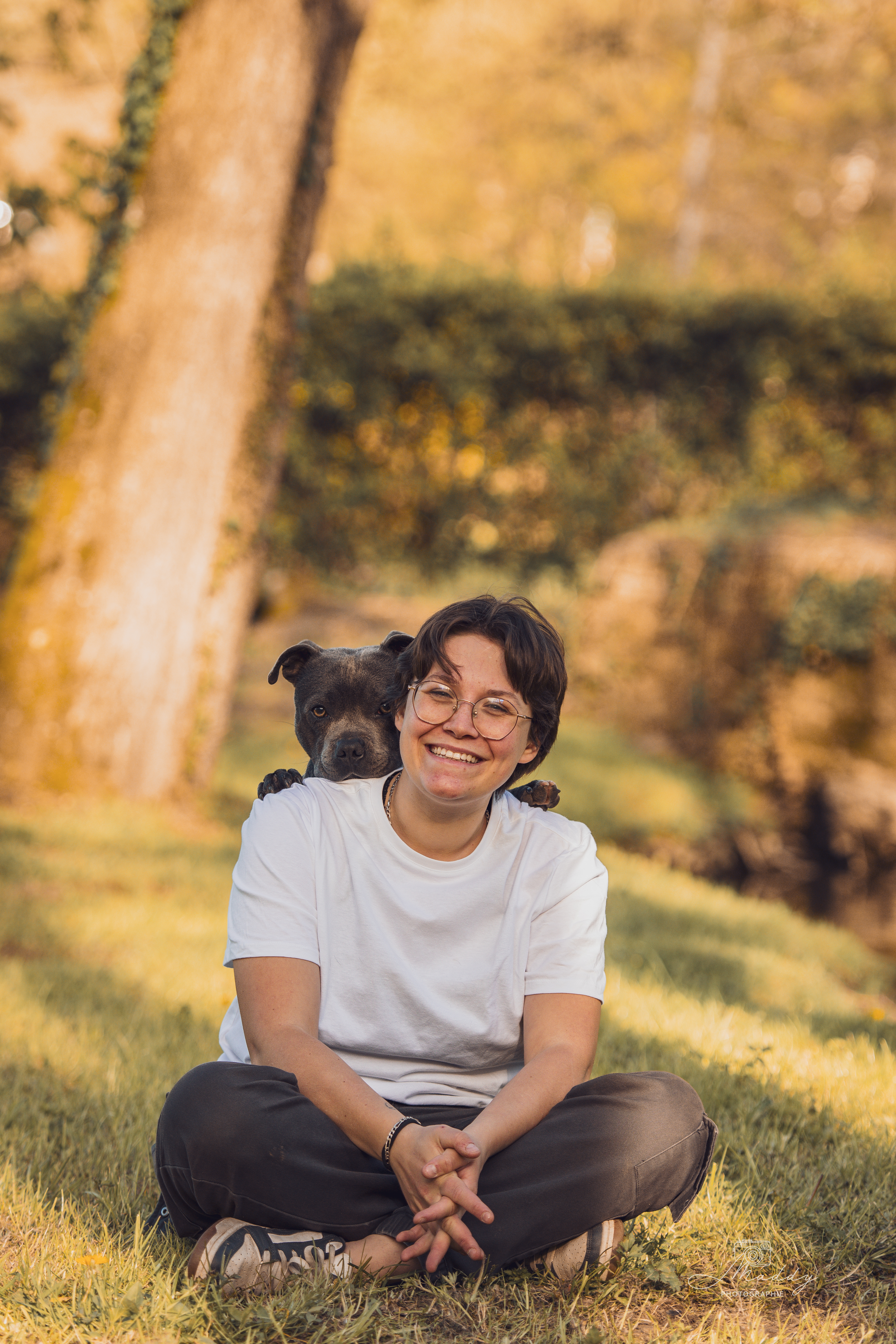 Adély souriante en extérieur avec son chien